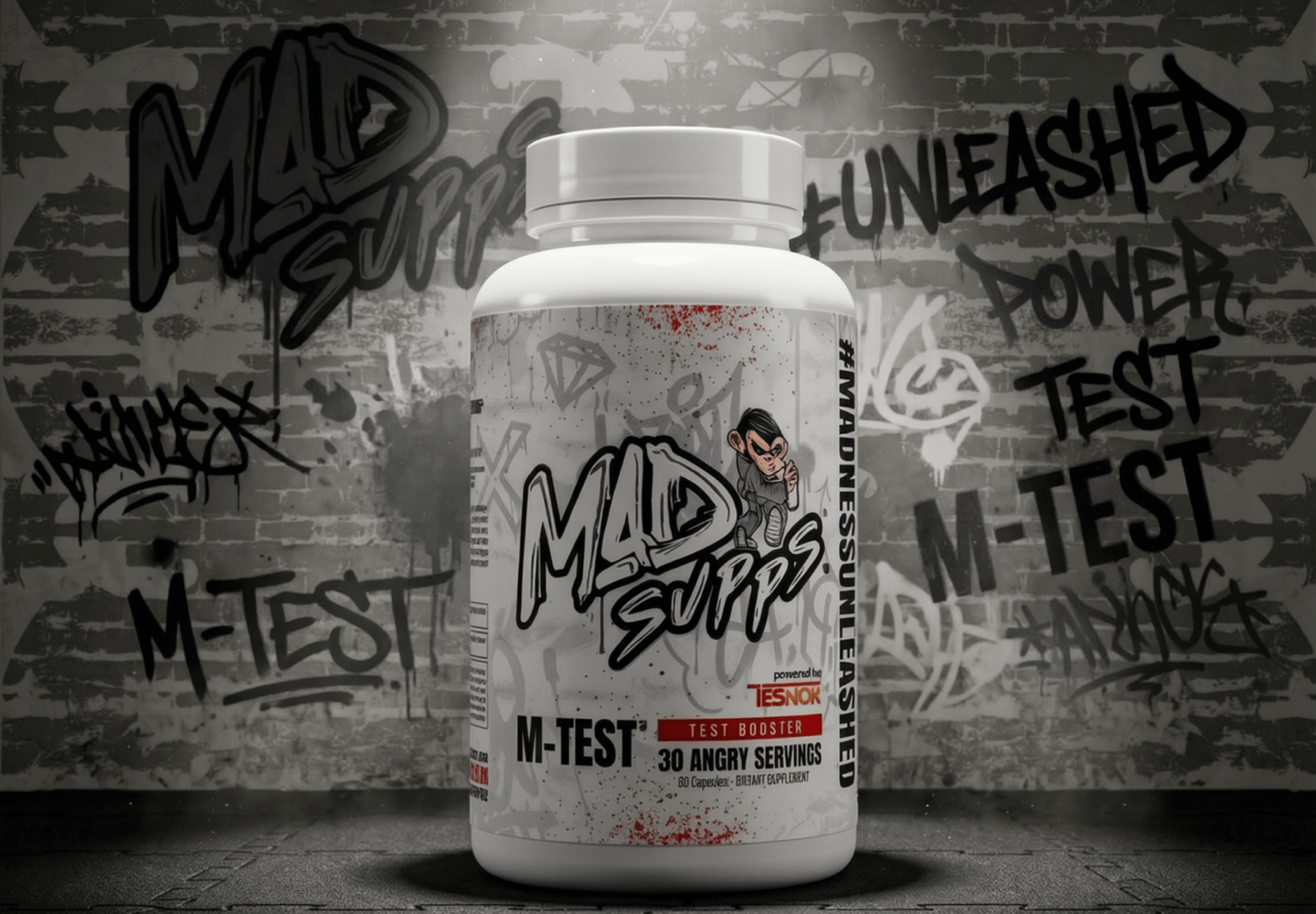 White bottle with graffiti-covered wall background, labeled M-TEST, a test booster supplement.