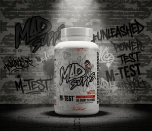 White bottle with graffiti-covered wall background, labeled M-TEST, a test booster supplement.